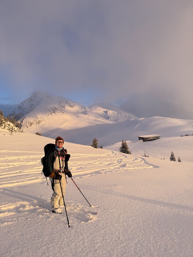 Jon backcountry skiing in snowy mountains